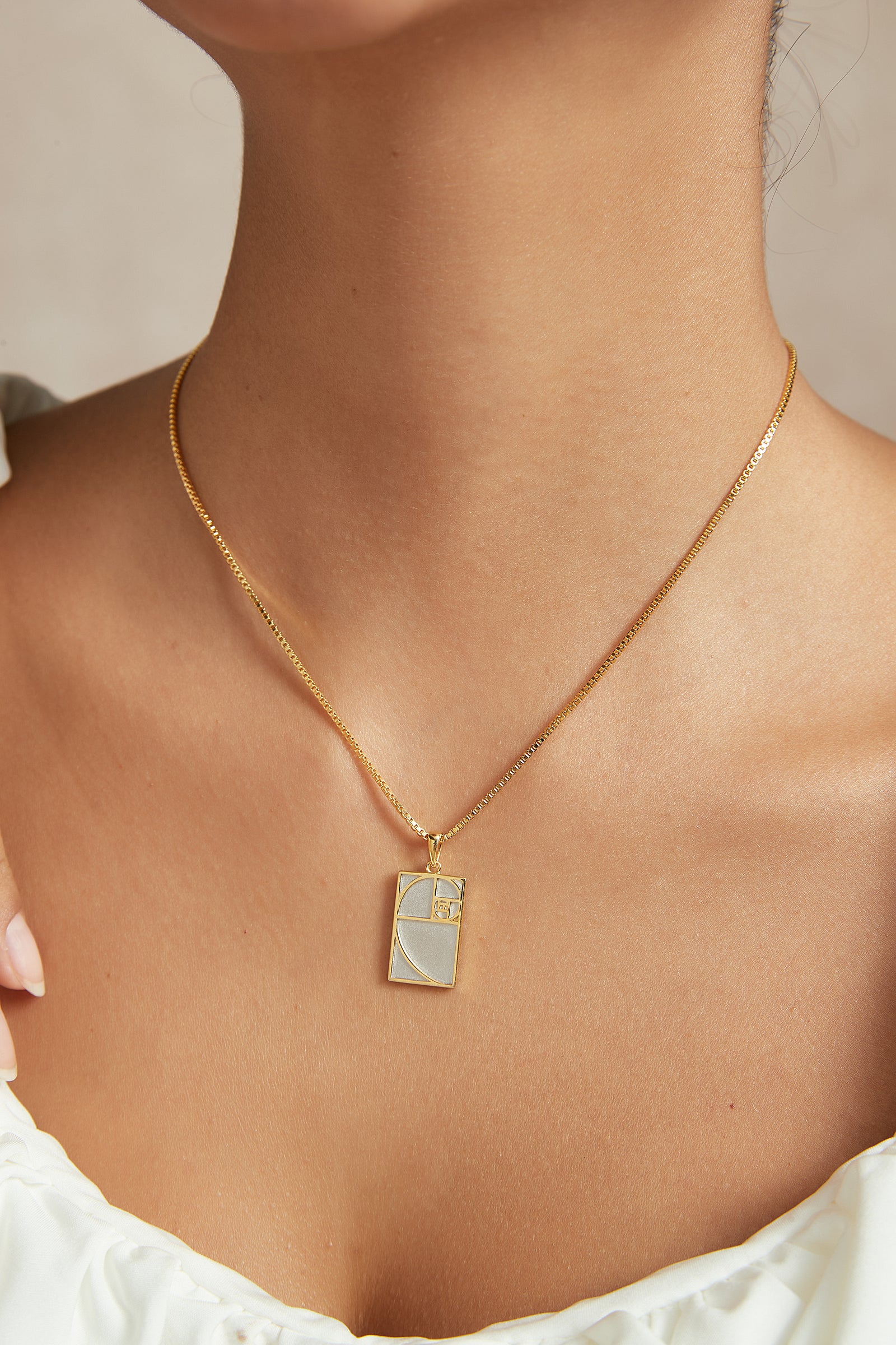 Gold and silver geometric pendant necklace worn on model - GL.rareness