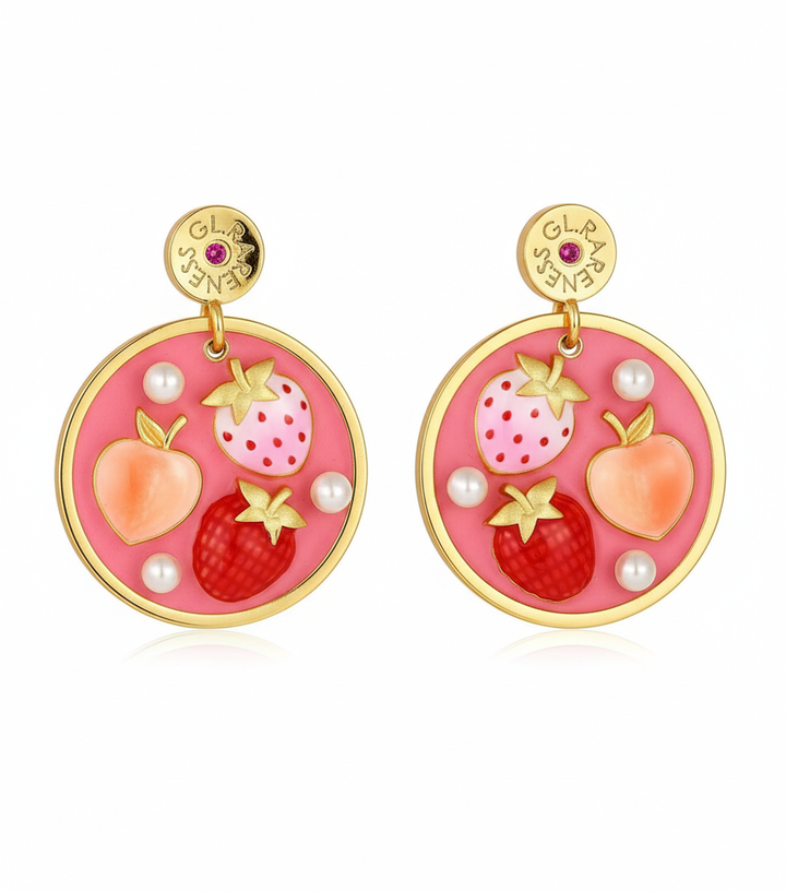 pink enamel round disc drop earrings featuring two strawberries (one light pink with red dots, one deep red with crosshatch texture) and one coral peach, accented with small white pearls and gold calyx details, hanging from branded GL.RARENESS gold disc studs with pink stone, gold bezel frame, shown as pair on white background
