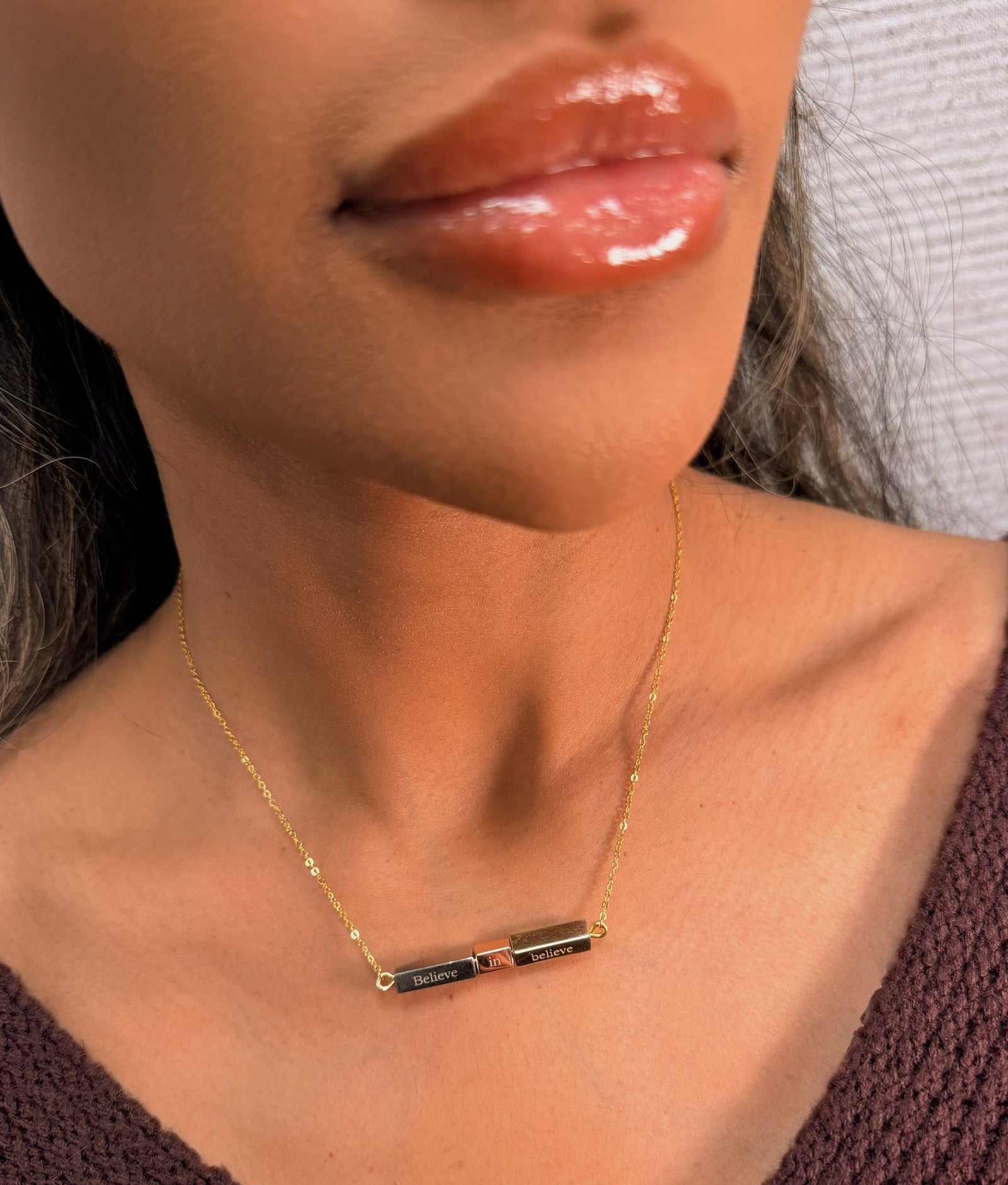 woman wearing tri-color gold bar necklace with believe in believe engraving